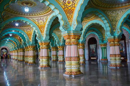 Free Vibrant and ornately decorated interior of the Mysore Palace, featuring colorful arches and pillars. Stock Photo