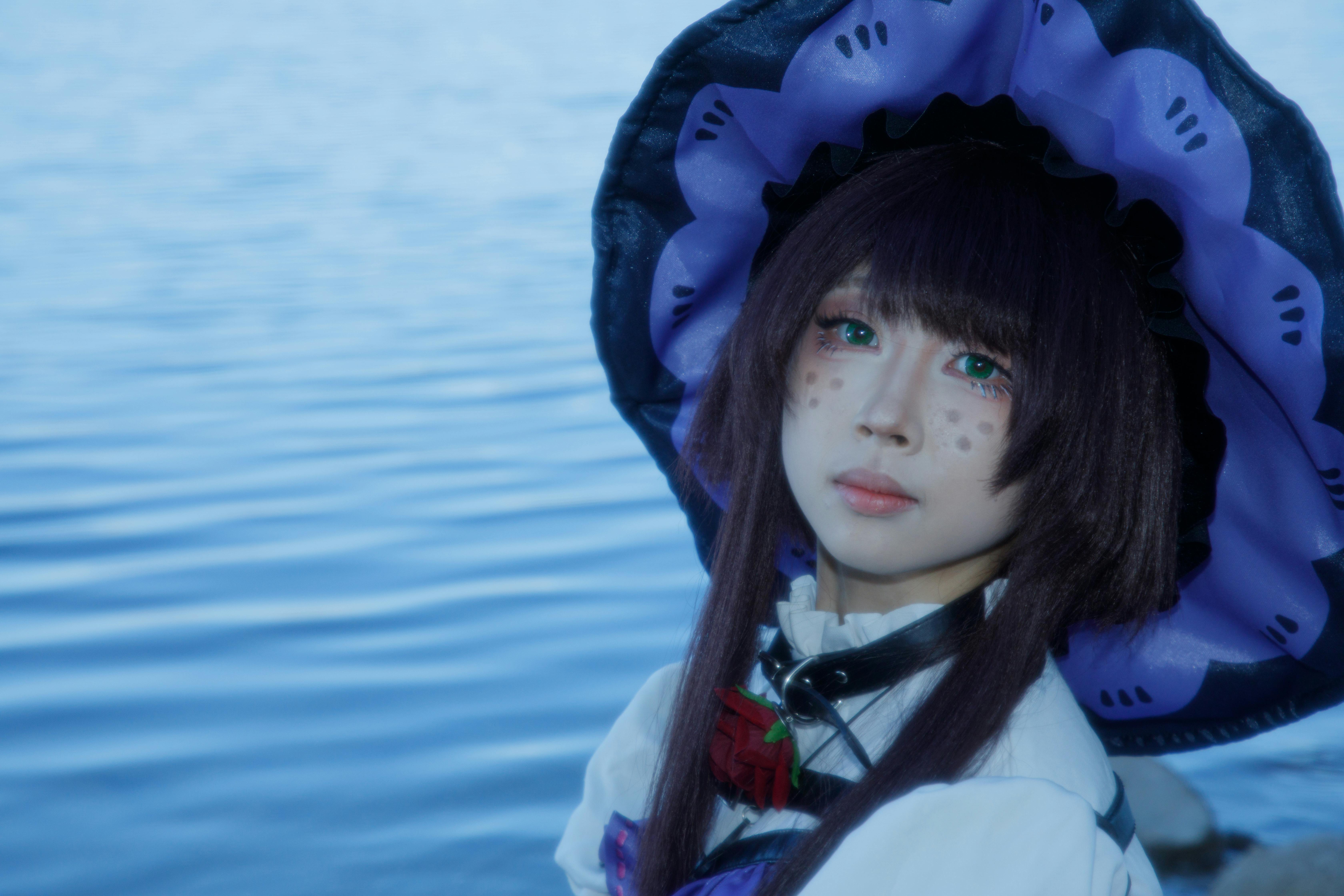 Vibrant cosplay portrait of a young adult in costume by a serene lakeside in China.