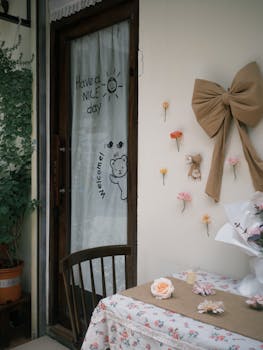 Cozy outdoor setting with floral table and welcome message on door.