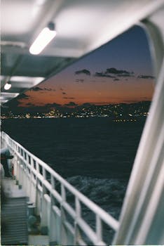 A scenic view of Istanbul's skyline during sunset, captured from a ferry with vibrant skies.