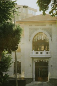 Capture of a beautiful historic building's facade illuminated by soft morning light, creating a timeless atmosphere.
