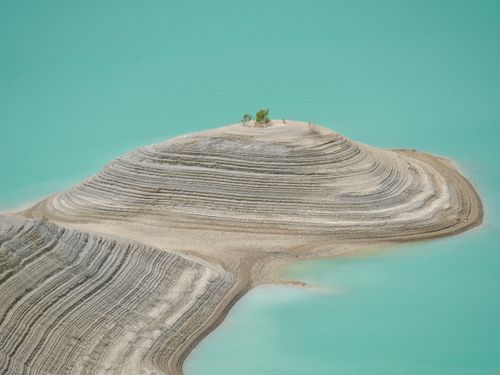 Free Aerial view of a unique striated island surrounded by turquoise waters. Nature's art. Stock Photo