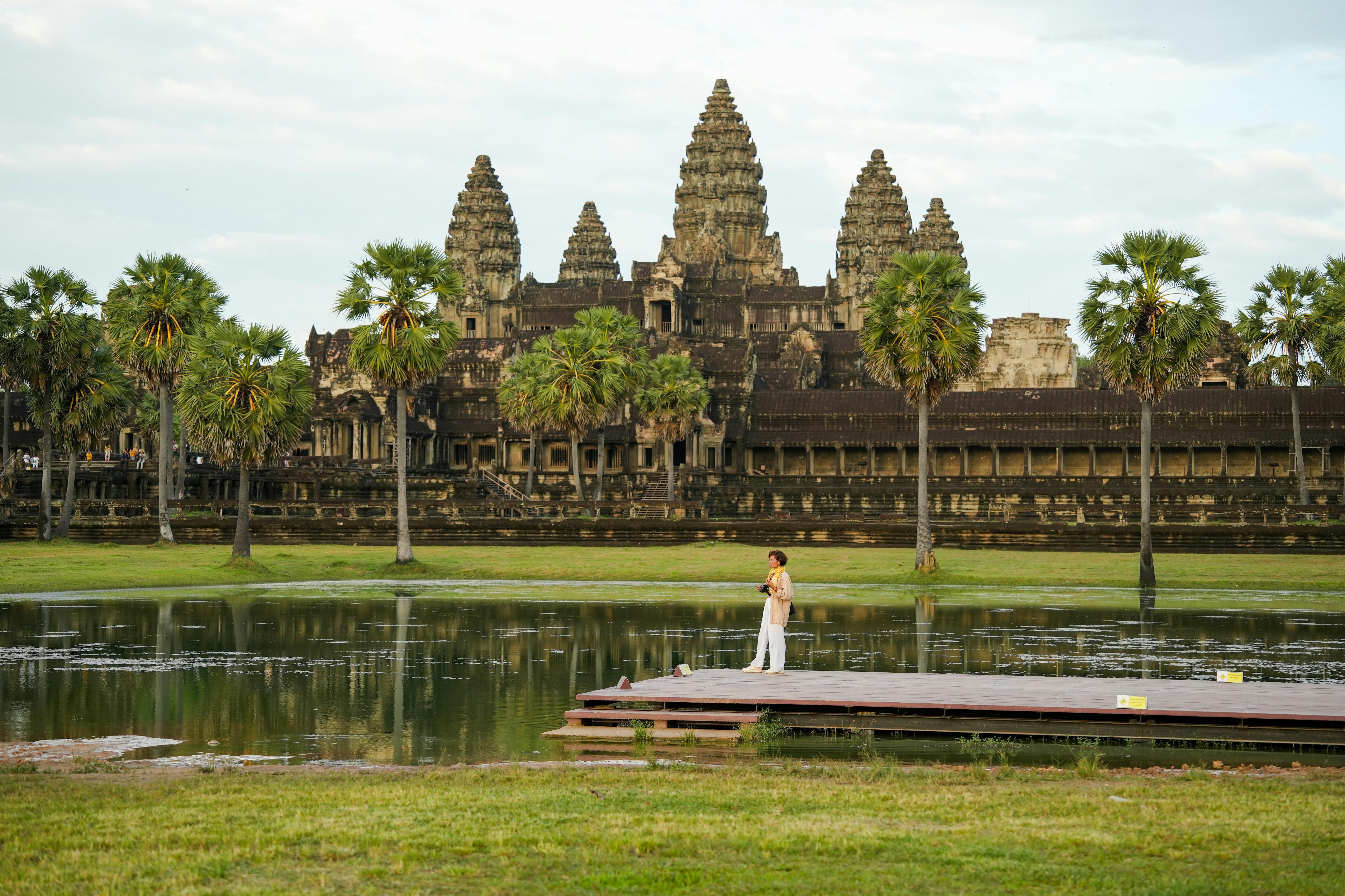 A lady is standing on the spot at Angkor Wat Temple.