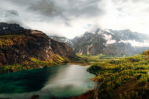 Breathtaking view of a tranquil lake surrounded by majestic alpine mountains in Austria.