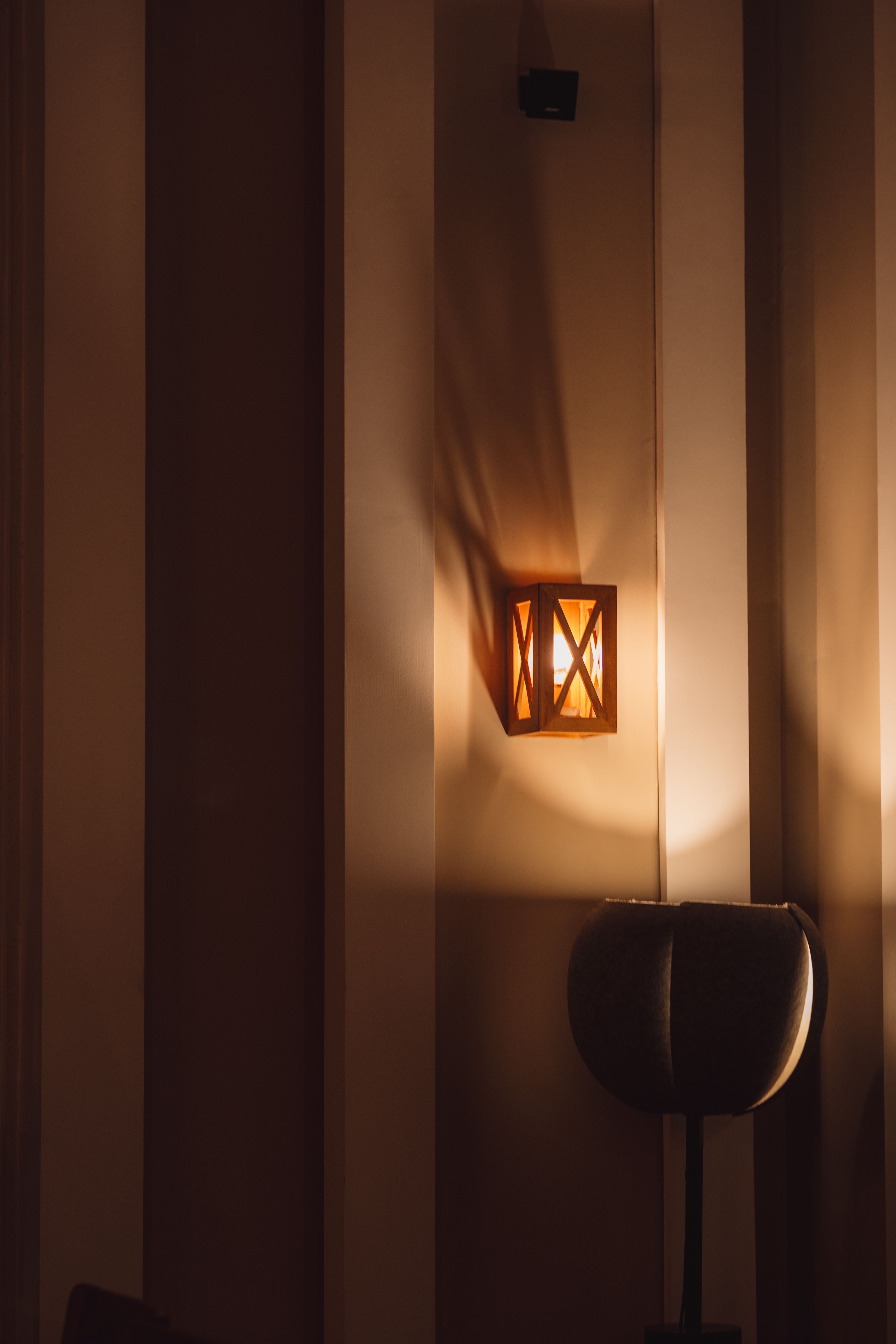 A cozy indoor lighting setup with a rustic lamp casting a warm glow in a modern interior design.