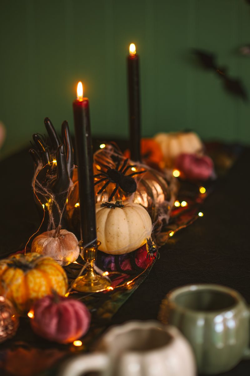 Elegant Halloween table decor with candles and pumpkins