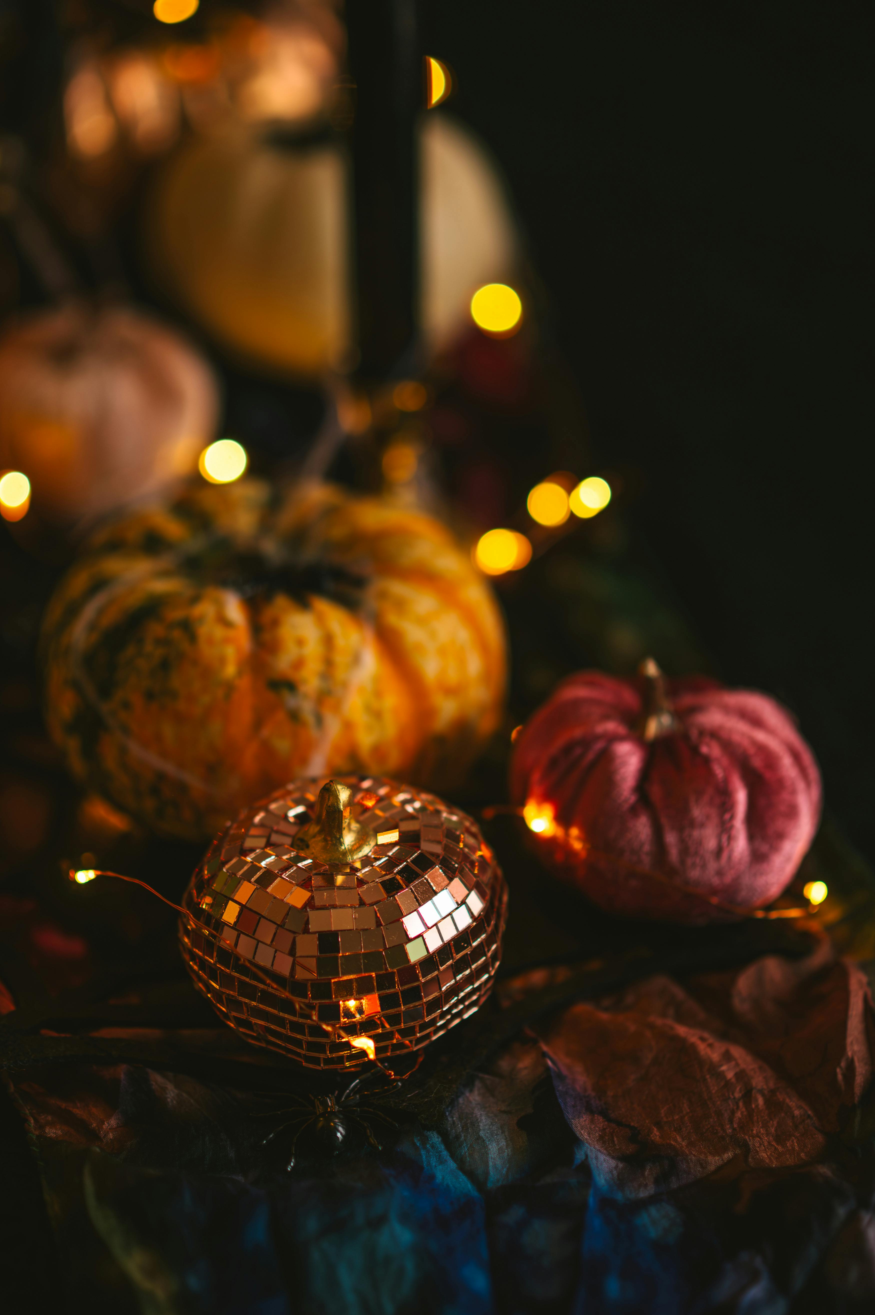 Warm autumnal scene featuring decorative pumpkins with glistening lights, perfect for fall ambiance.