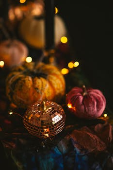 Warm autumnal scene featuring decorative pumpkins with glistening lights, perfect for fall ambiance.