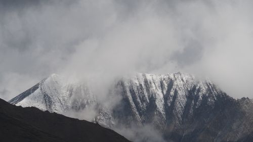 Free Stunning view of snow-covered mountains under dramatic clouds in Kazbegi, Georgia. Stock Photo