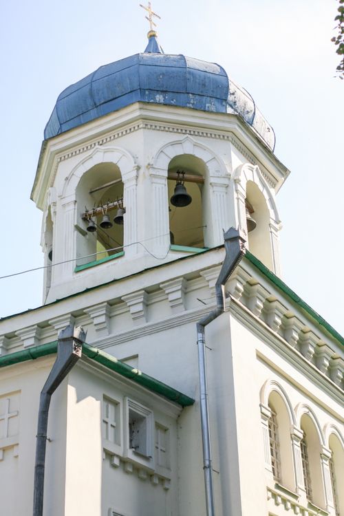 Free A detailed view of a historic Orthodox church bell tower with a blue dome and white walls. Stock Photo