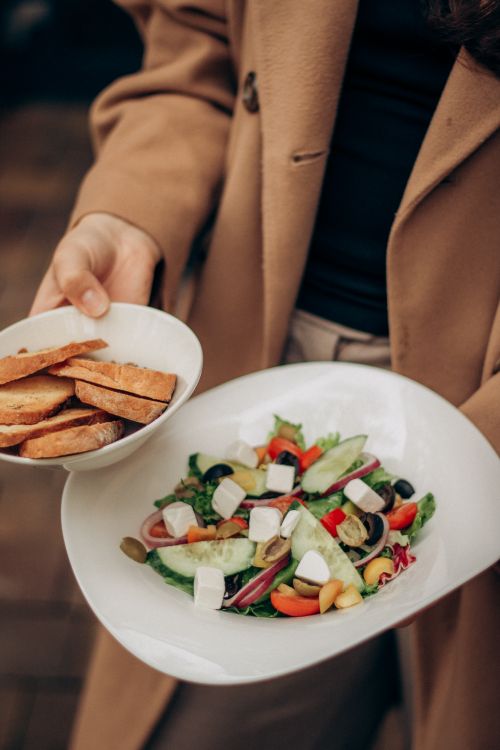 Free Close-up of a colorful Mediterranean salad with fresh vegetables and bread slices. Stock Photo