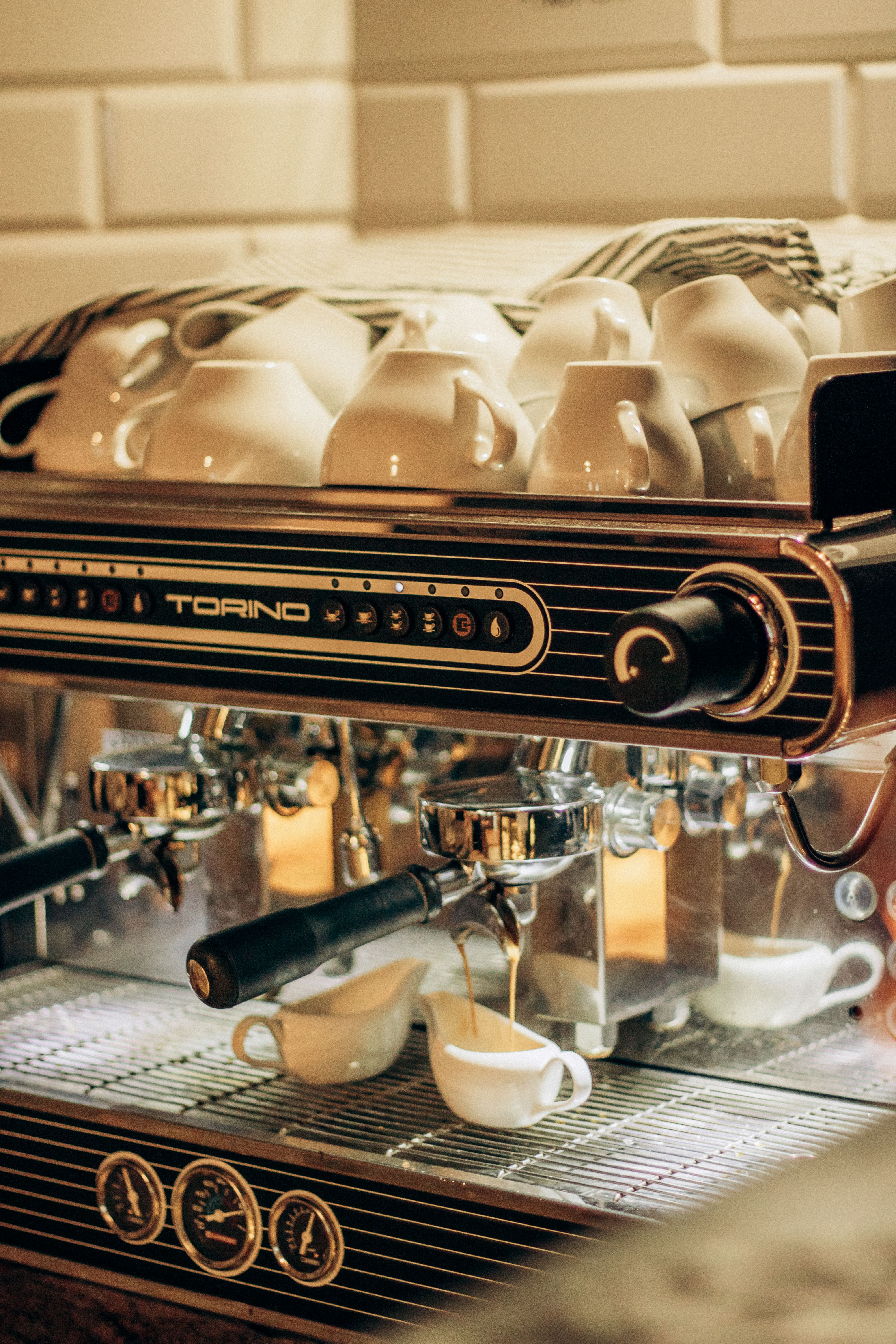 Close-up of an espresso machine making fresh coffee in a cozy café setting.