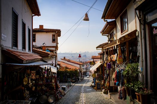 Explore a picturesque old bazaar street in Ankara, Türkiye, showcasing traditional architecture and market stalls.