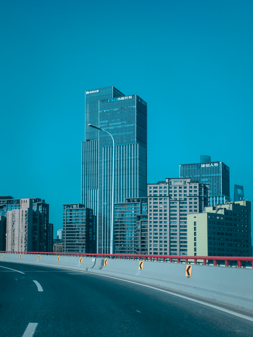 Free Cityscape featuring modern high-rise buildings against a clear blue sky. Stock Photo