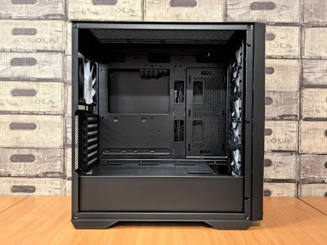 Black empty computer case on desk, ideal for gaming setup with visible airflow design.