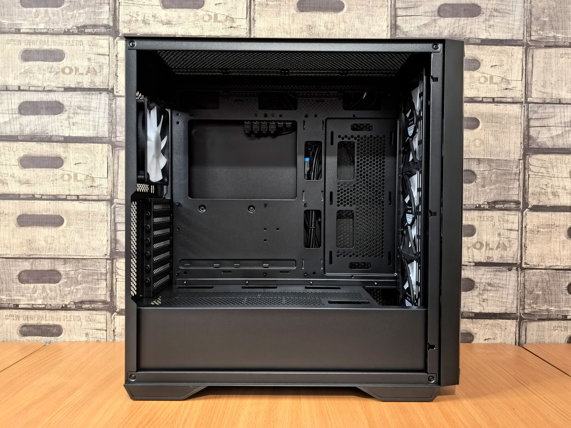 Empty black computer case on wooden desk · Free Stock Photo