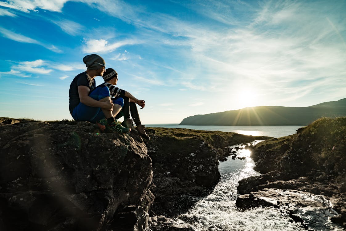 Two Man Sitting on Cliff