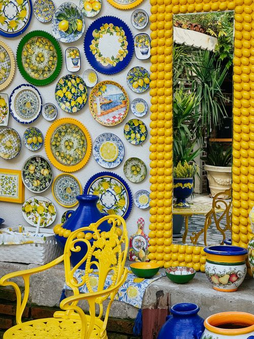 Free Colorful lemon-themed ceramics and mirror outdoors showcasing summer vibes. Stock Photo