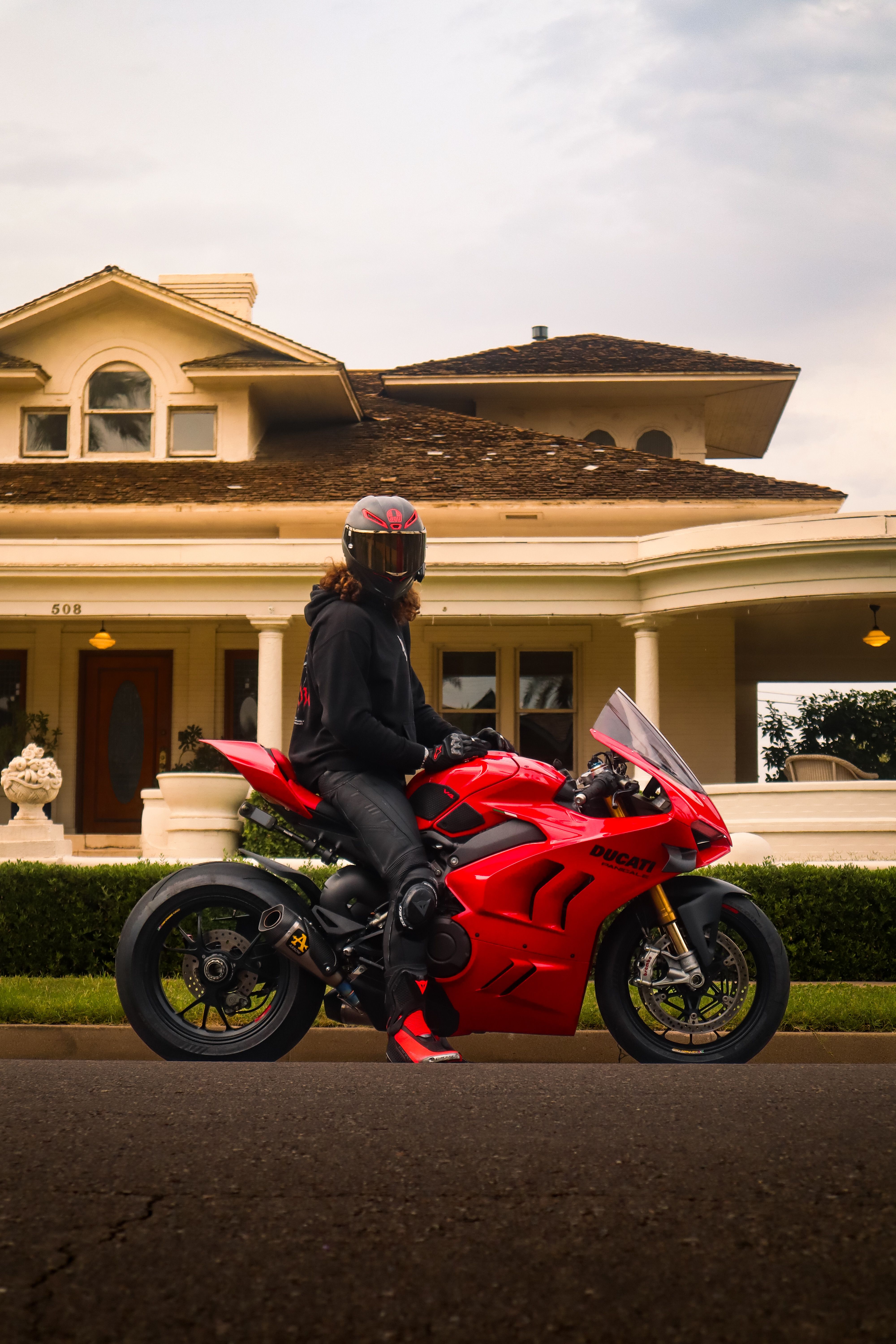 Rider on Red Motorcycle in Front of Classic House · Free Stock Photo