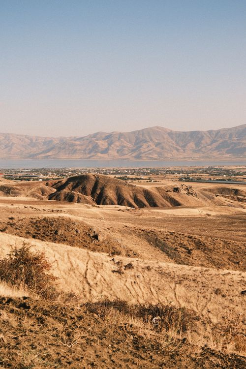 Free Wide view of arid desert plains and distant mountain range under clear blue sky. Stock Photo