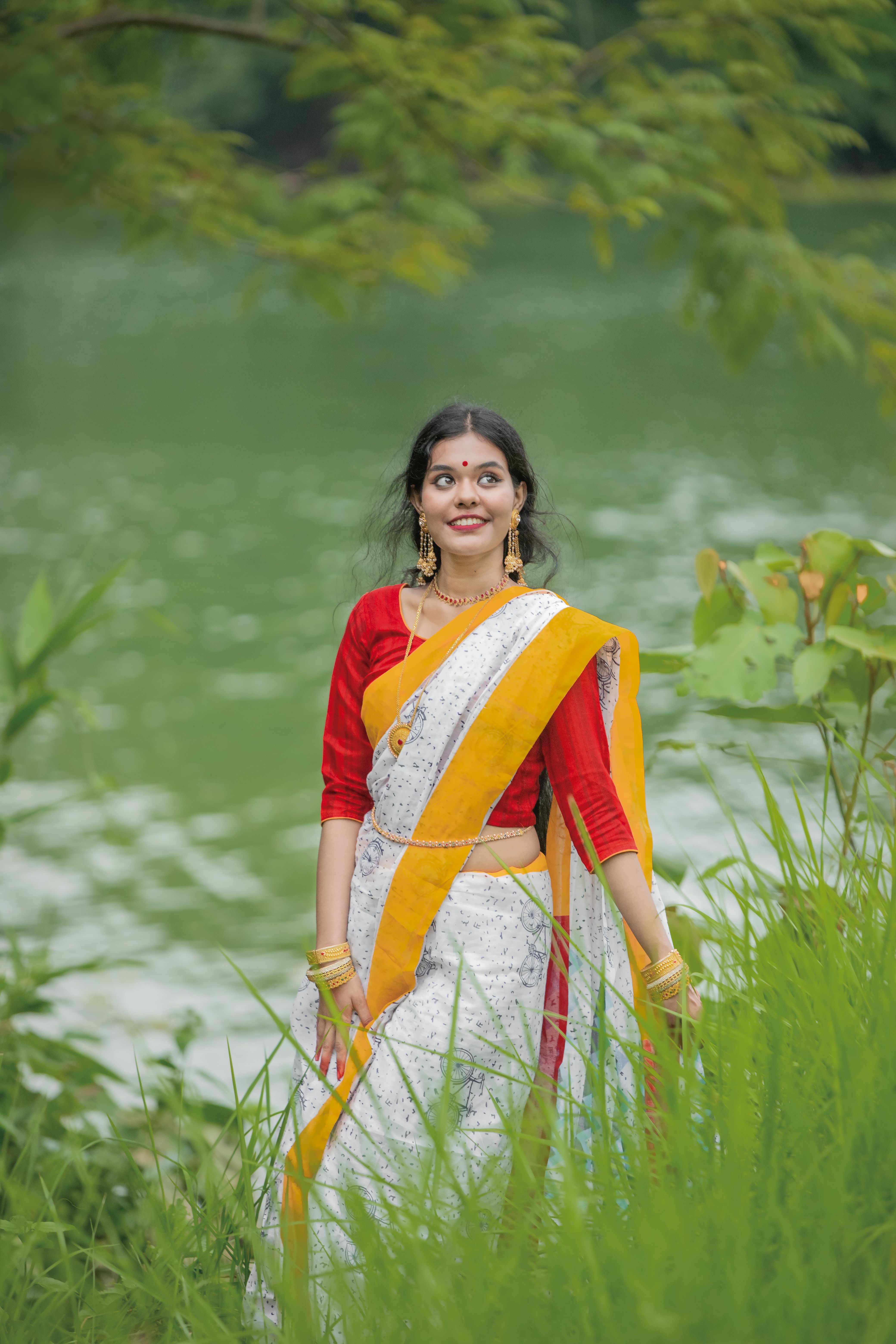 Elegant Woman in Traditional Indian Saree by Lake · Free Stock Photo