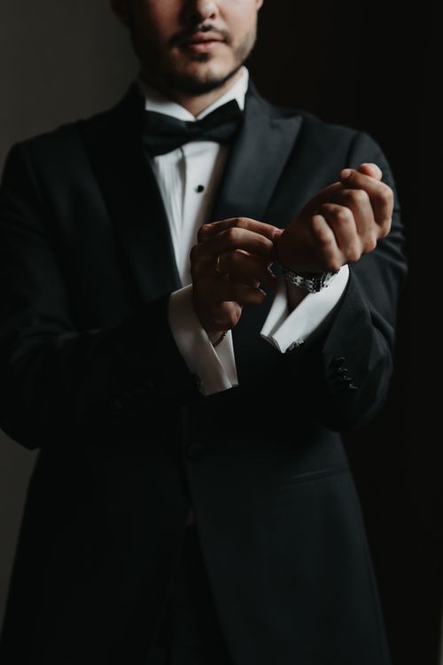 Free Stylish adult male in a tuxedo adjusting cufflinks, portrait shot Stock Photo