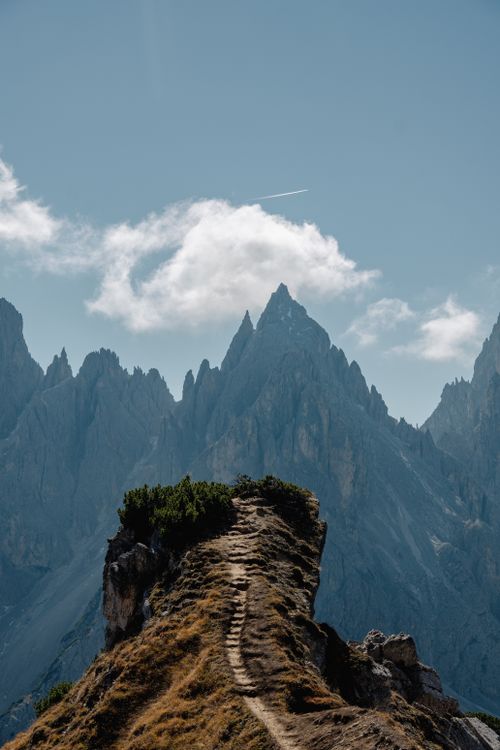 Free Breathtaking view of a mountain path leading into the Dolomites under a clear sky. Stock Photo