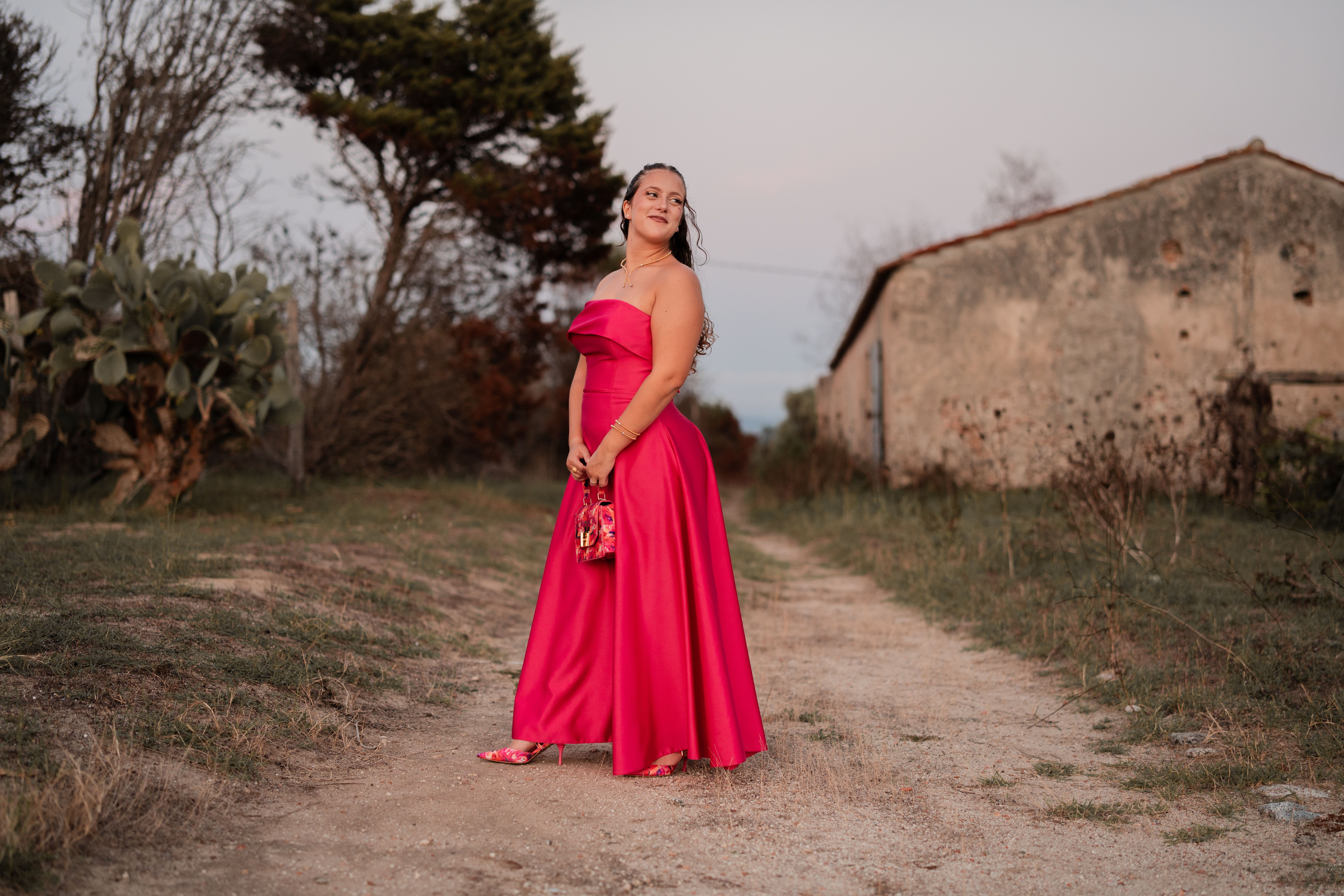 Elegant Woman in Red Dress Outdoors at Twilight · Free Stock Photo