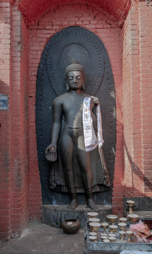 Free Historic Buddha statue in Kathmandu, Nepal, adorned with traditional offerings. Stock Photo