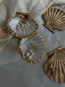 Luxurious earrings with pearls and gold on decorative seashells. Perfect for a chic, refined look.