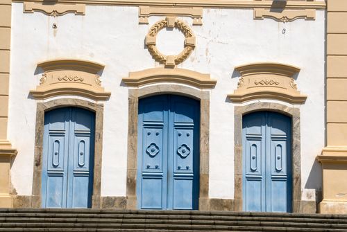 Free Sunlit historic blue doors on a vintage building in Rio de Janeiro, Brazil. A blend of classic architecture and vibrant color. Stock Photo