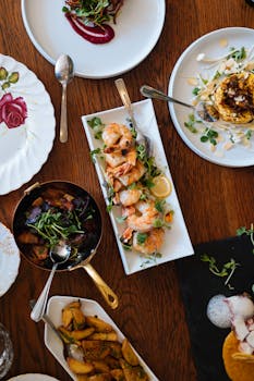 An overhead view of a beautifully arranged dining table featuring various gourmet dishes, perfect for a culinary experience.