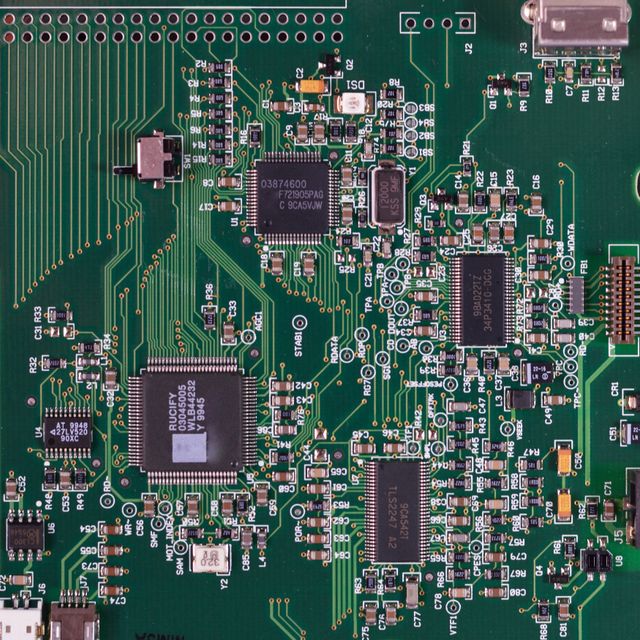 Macro view of a populated green circuit board — photo by Miguel Á. Padriñán on Pexels