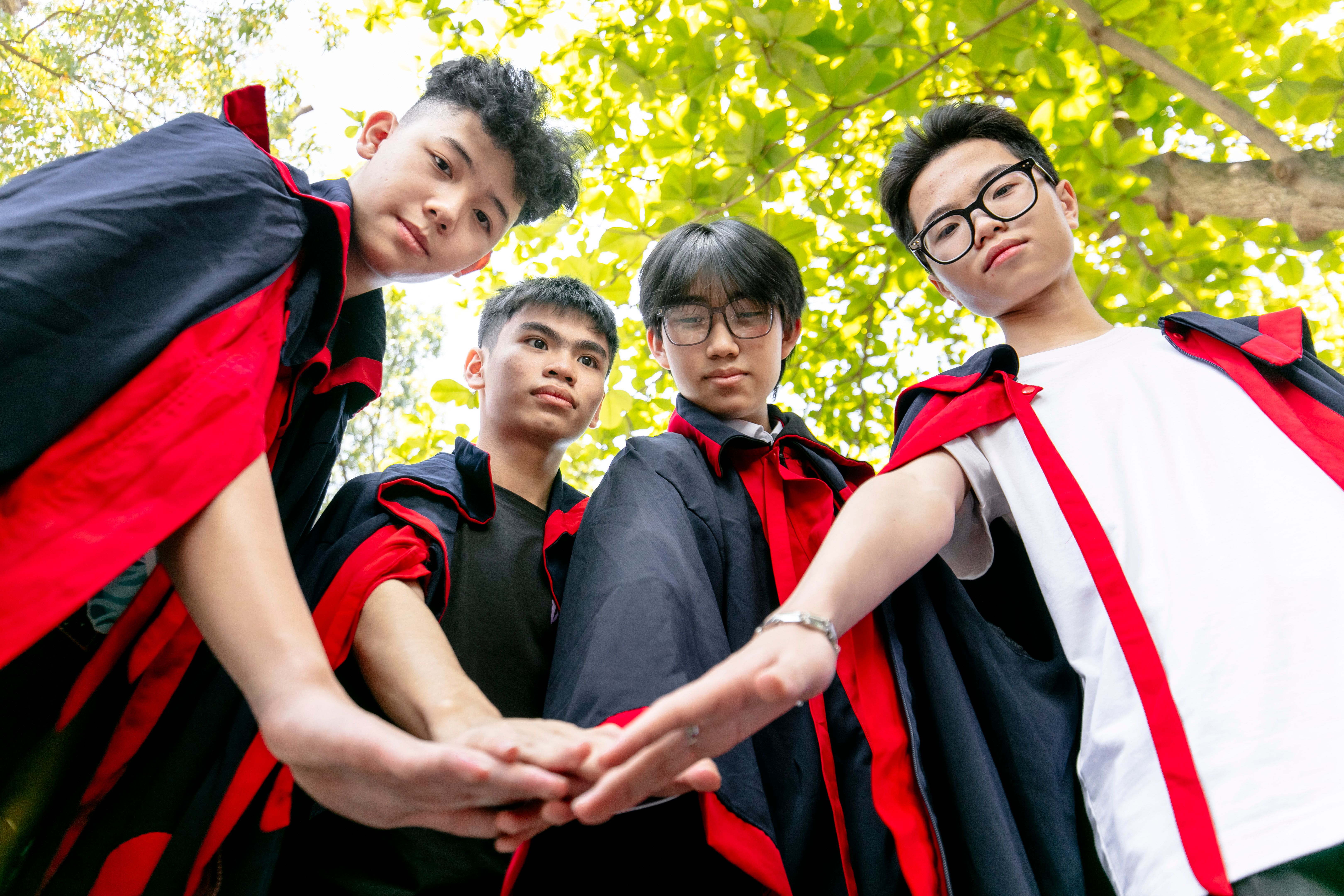 Graduates Celebrating Teamwork and Friendship Outdoors · Free Stock Photo
