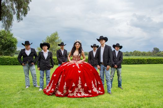 A vibrant quinceañera celebration outdoors in Dolores Hidalgo, Mexico showcasing traditional attire and cultural heritage.