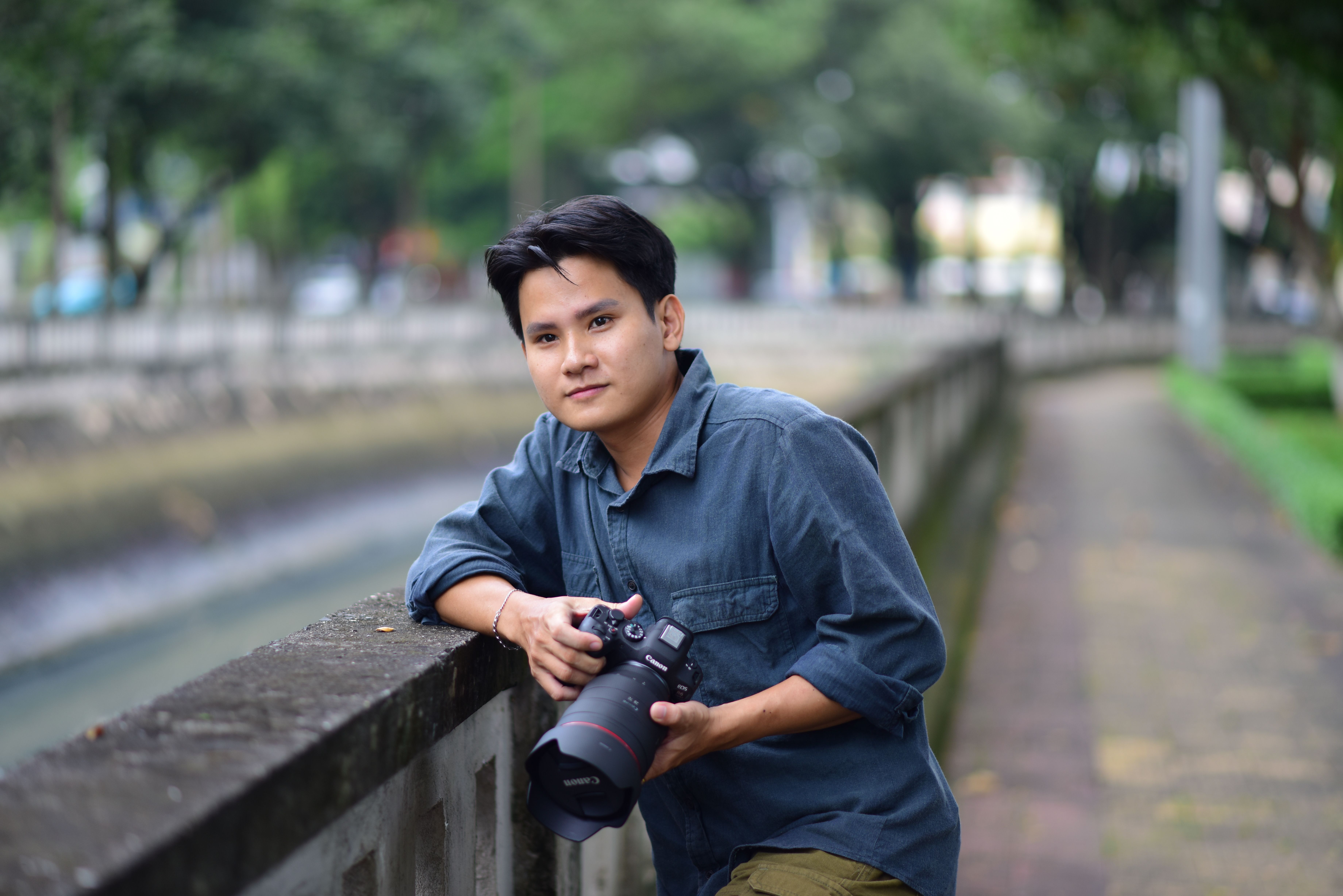 Young Photographer Outdoors with Camera · Free Stock Photo