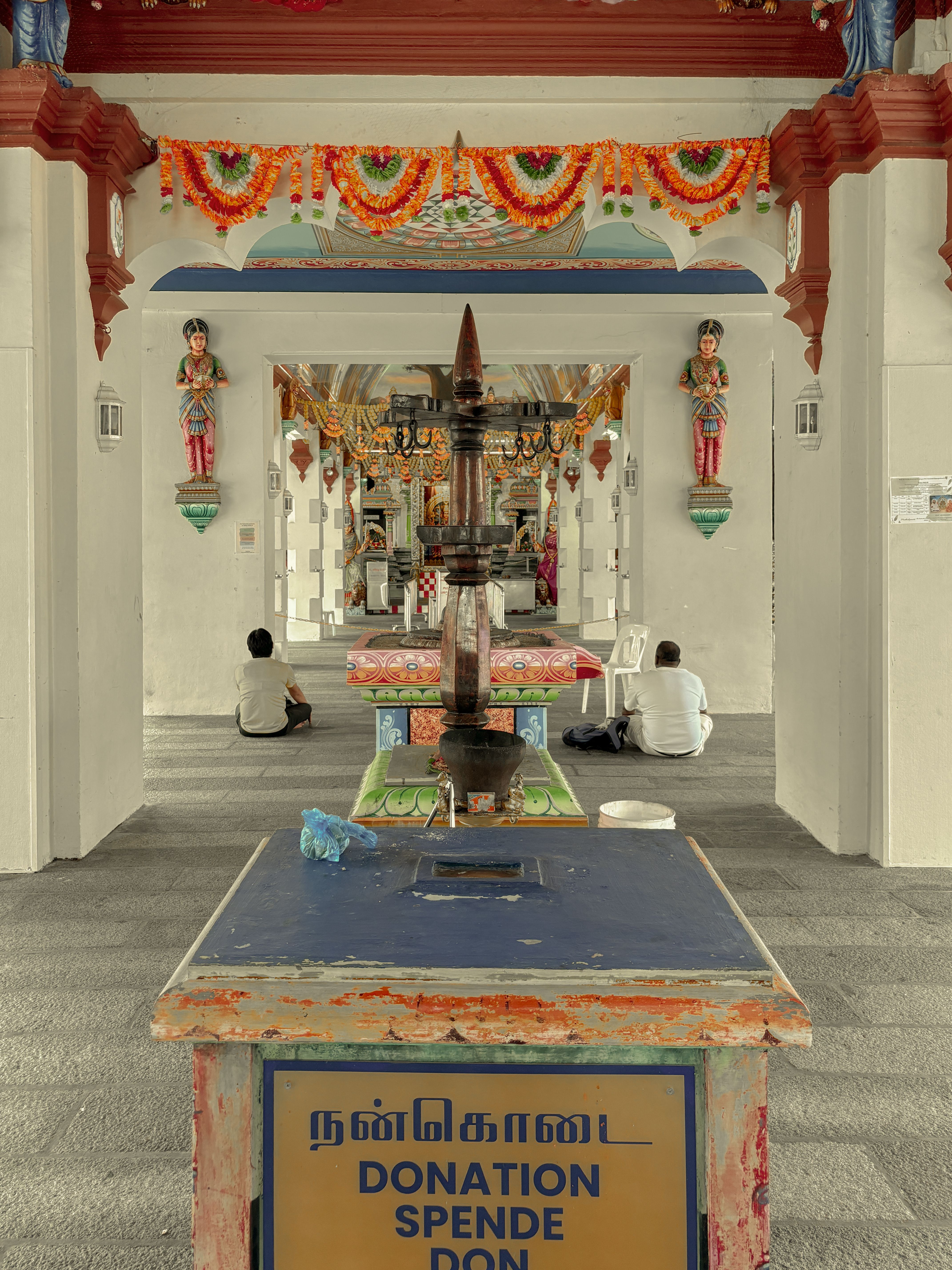 Explore a vibrant Hindu temple interior in Singapore with cultural decorations and architecture.