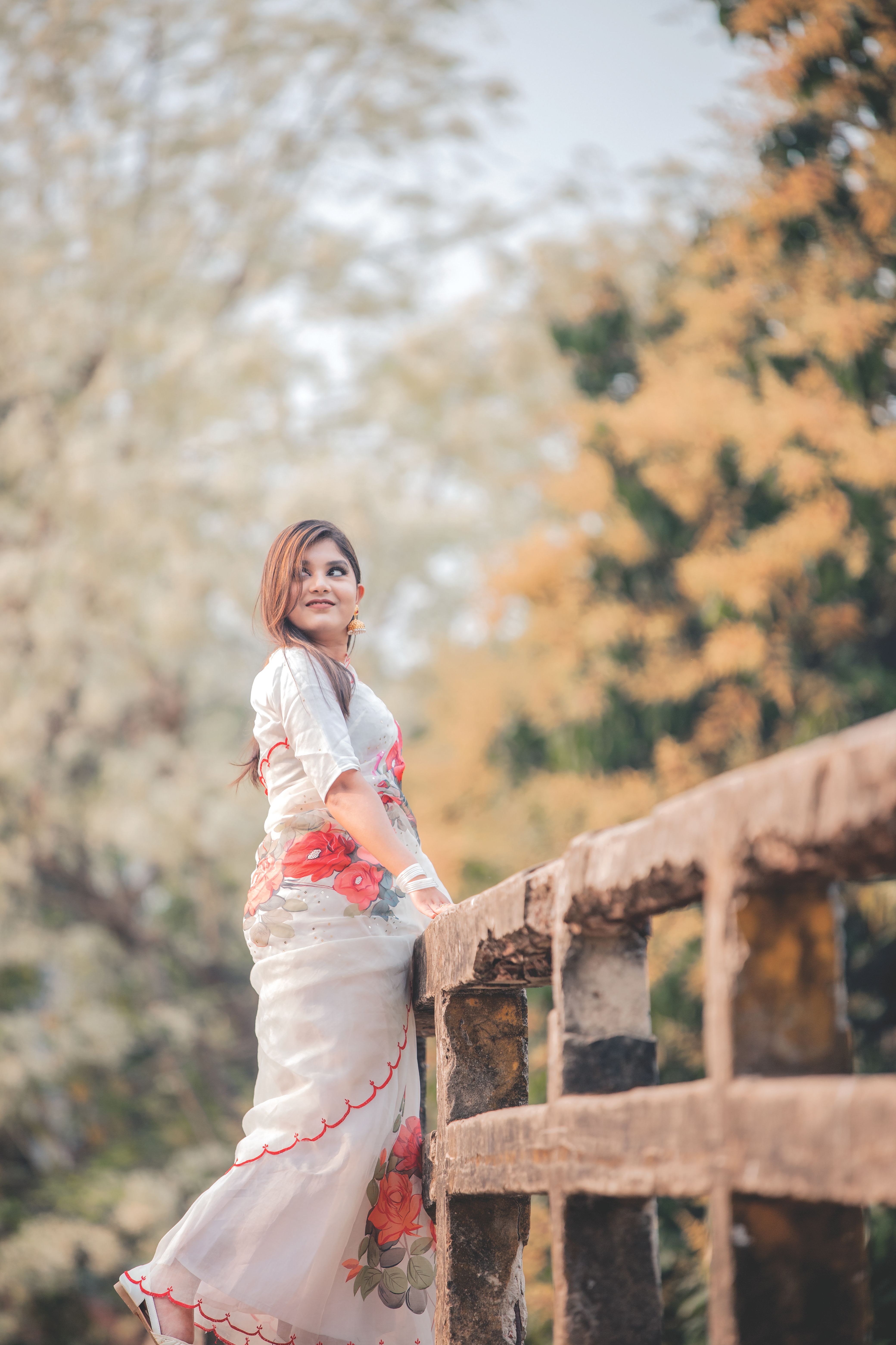 Portrait of Woman in Floral Dress Outdoors · Free Stock Photo