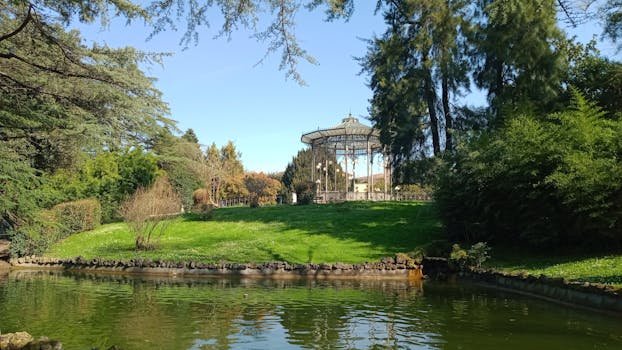 Scenic view of a gazebo surrounded by greenery and a tranquil lake in Benevento, Italy.