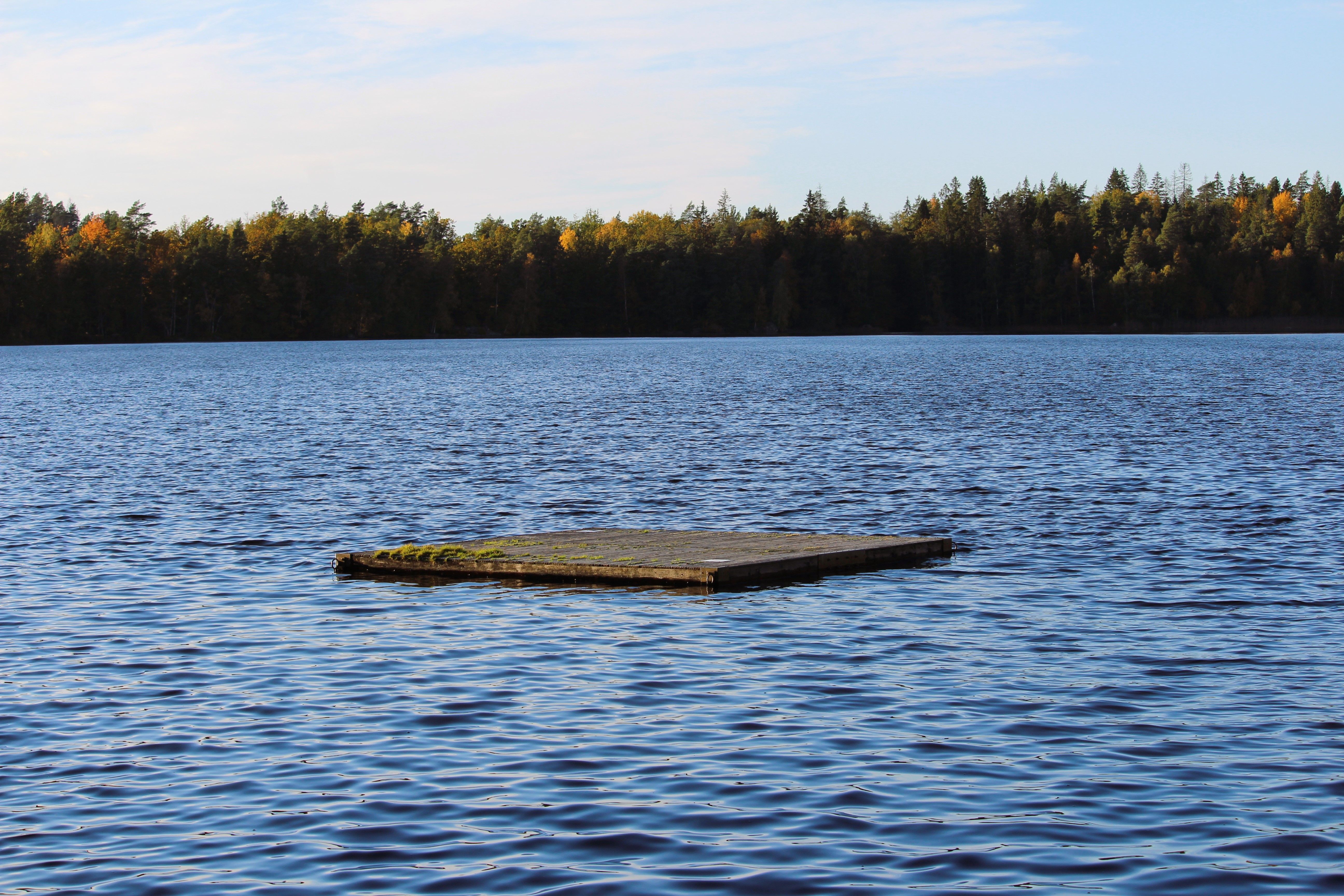 Tranquil Lake with Wooden Raft in Autumn · Free Stock Photo