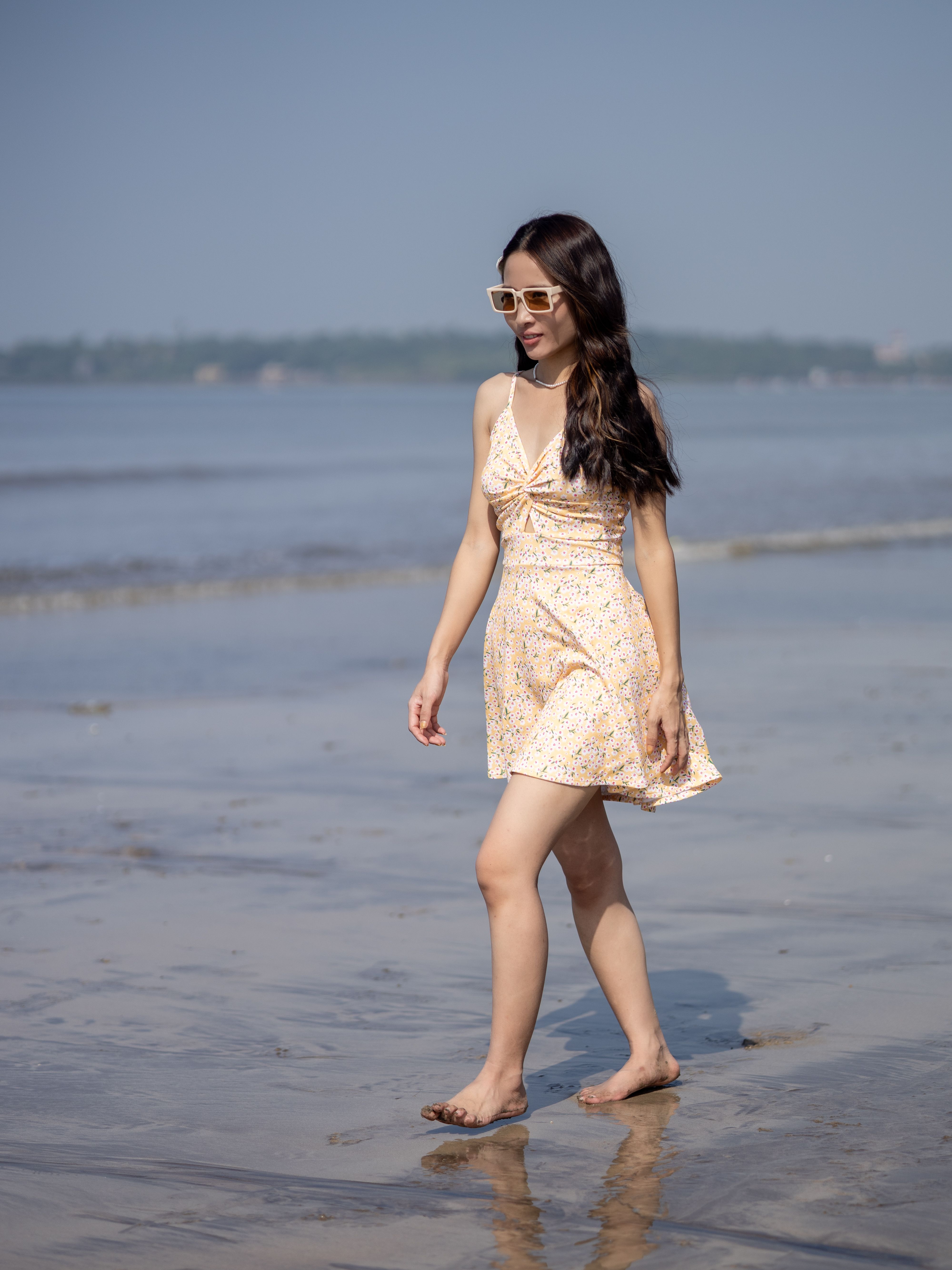 Young Woman Walking on a Sunny Beach · Free Stock Photo