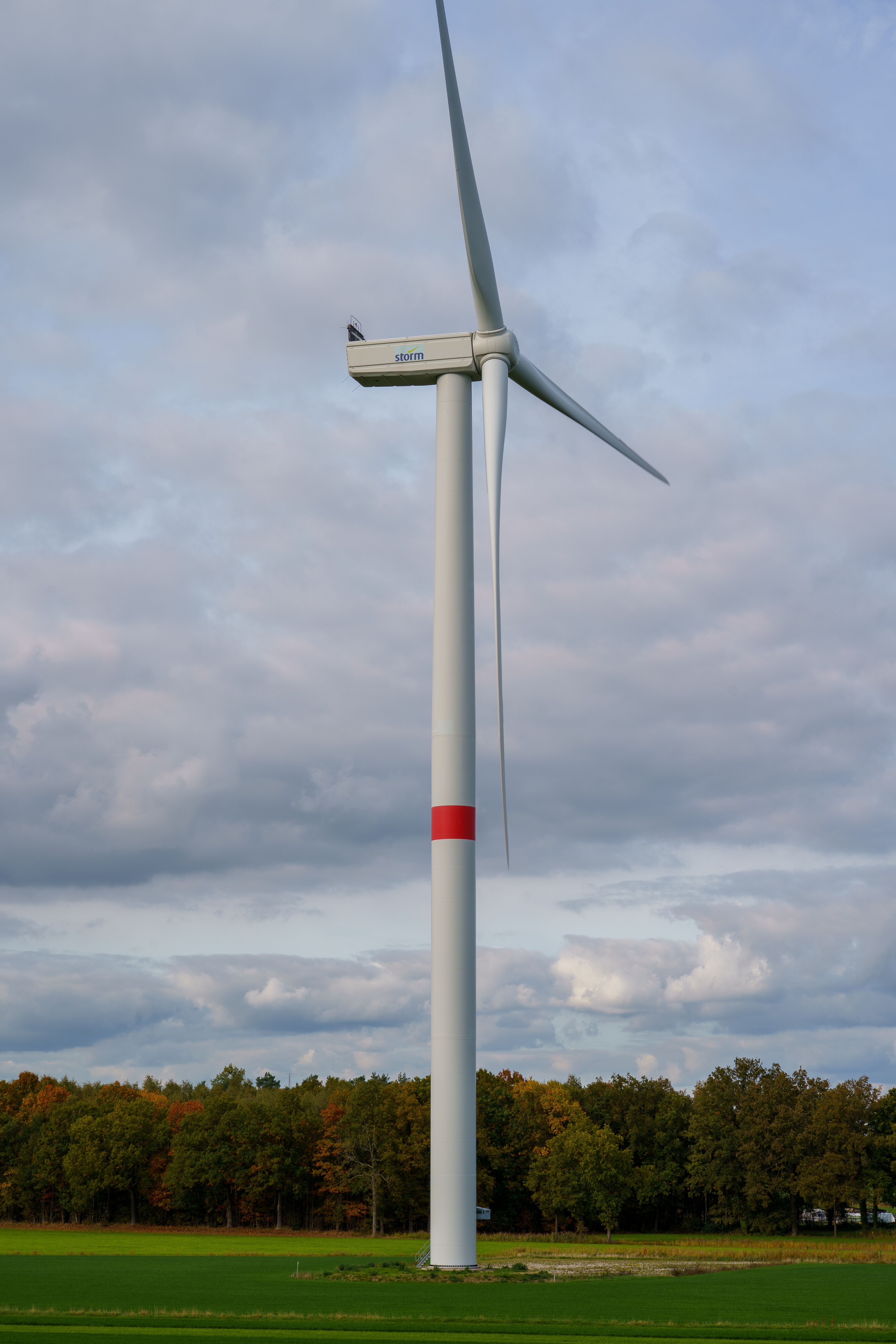 Wind Turbine in Open Field Under Cloudy Sky · Free Stock Photo