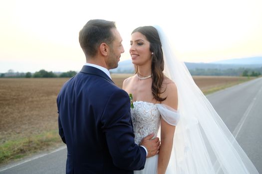 Romantic portrait of a couple on their wedding day in an outdoor setting with a stunning horizon.