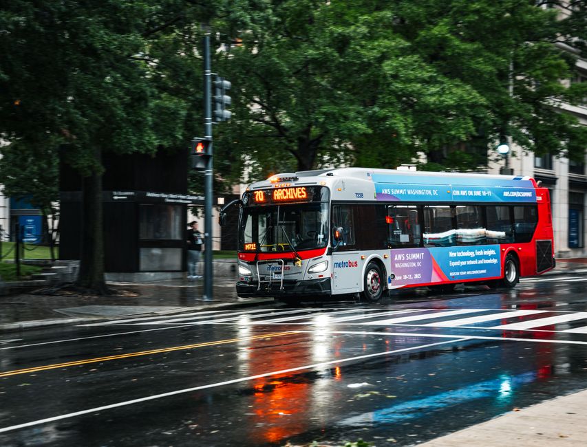 Rainy day city scene with a Metrobus driving through Washington D.C., USA.