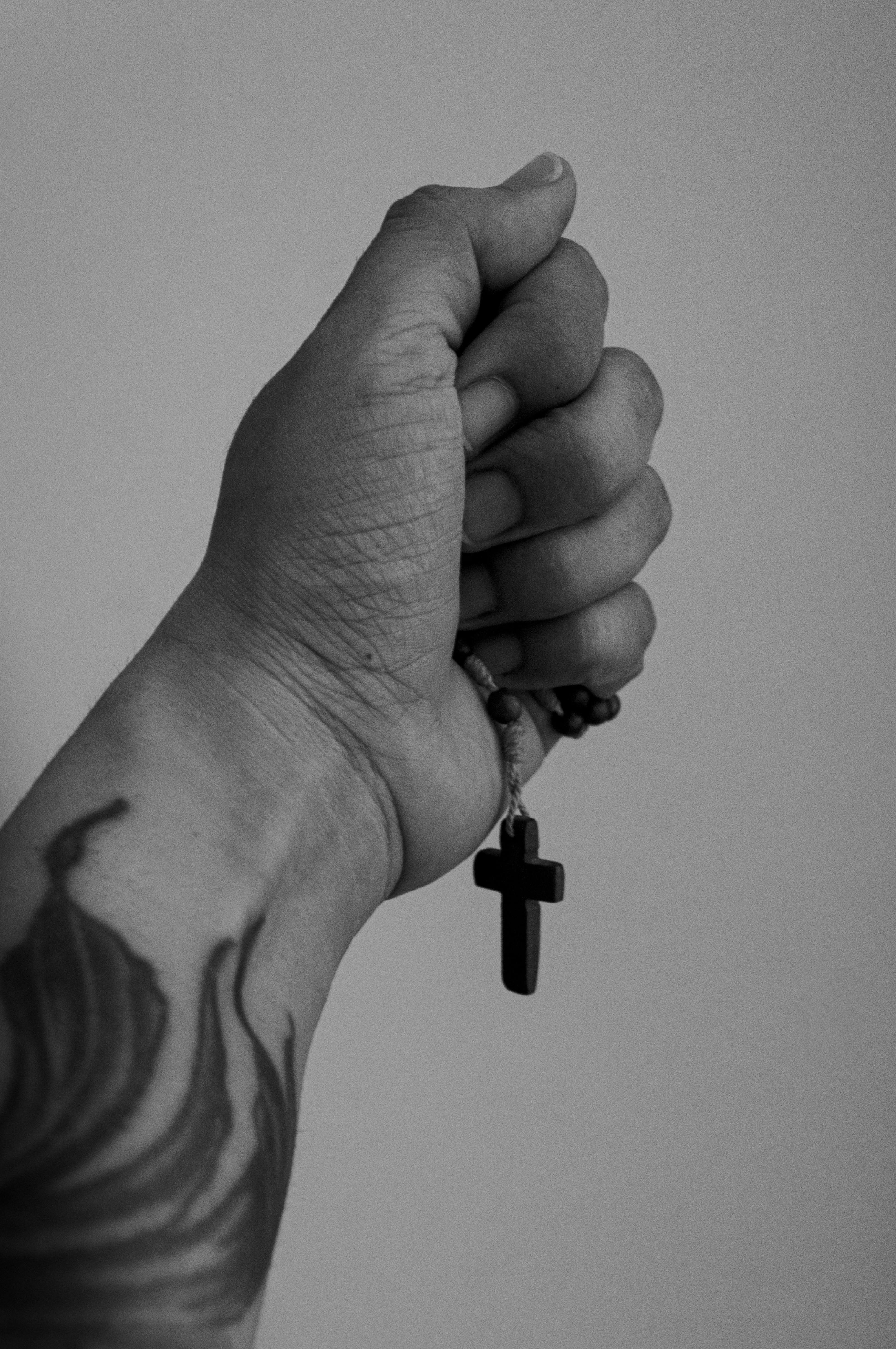 Person With Tattoos Holding Brown Cross · Free Stock Photo, image size:3238x4871