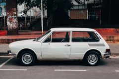 Classic white estate car parked on a street by Arth on Pexels