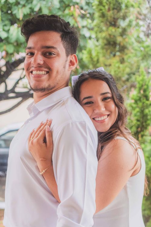 Free A cheerful couple embraces outdoors, showcasing love and happiness. Stock Photo