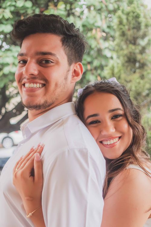 Free Joyful couple embracing and smiling in an outdoor setting, perfect for lifestyle themes. Stock Photo