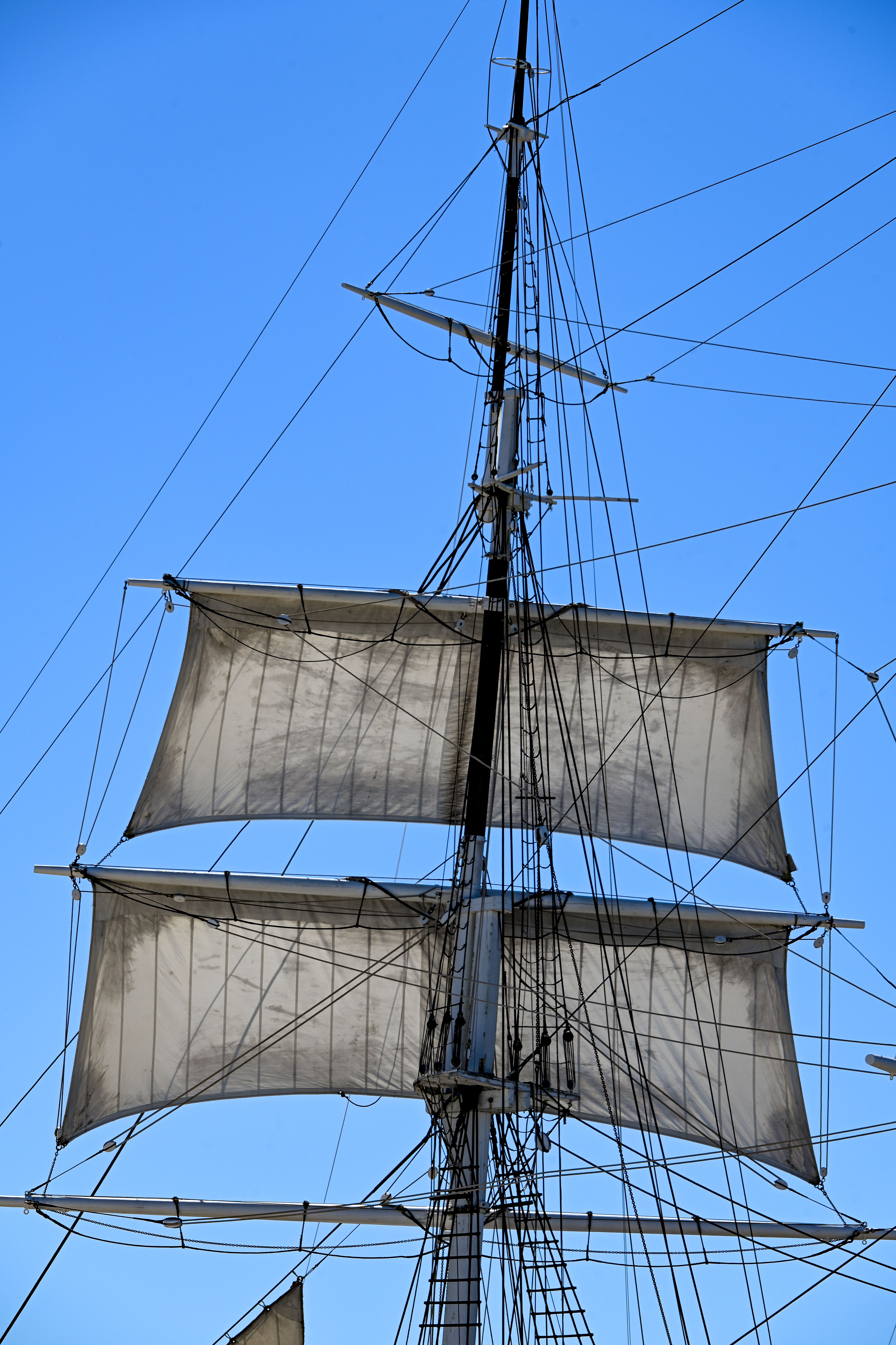 Historic Tall Ship Masts Against a Clear Blue Sky · Free Stock Photo