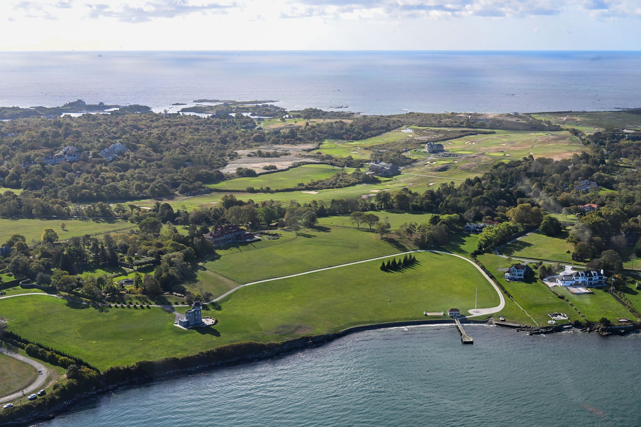 Stunning aerial view of Newport, Rhode Island's lush coastline and the Atlantic Ocean.
